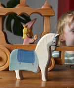 Ostheimer wooden white horse with saddle placed in front of the stage coach.
