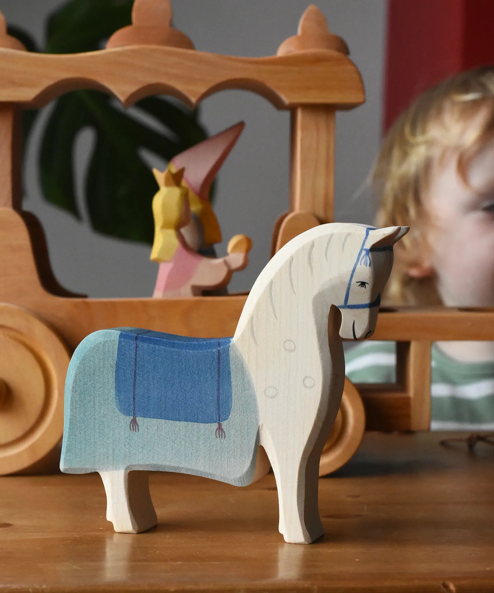Ostheimer wooden white horse with saddle placed in front of the stage coach.