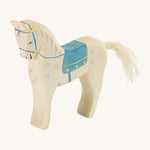 A white wooden horse figure with a blue saddle on a cream background