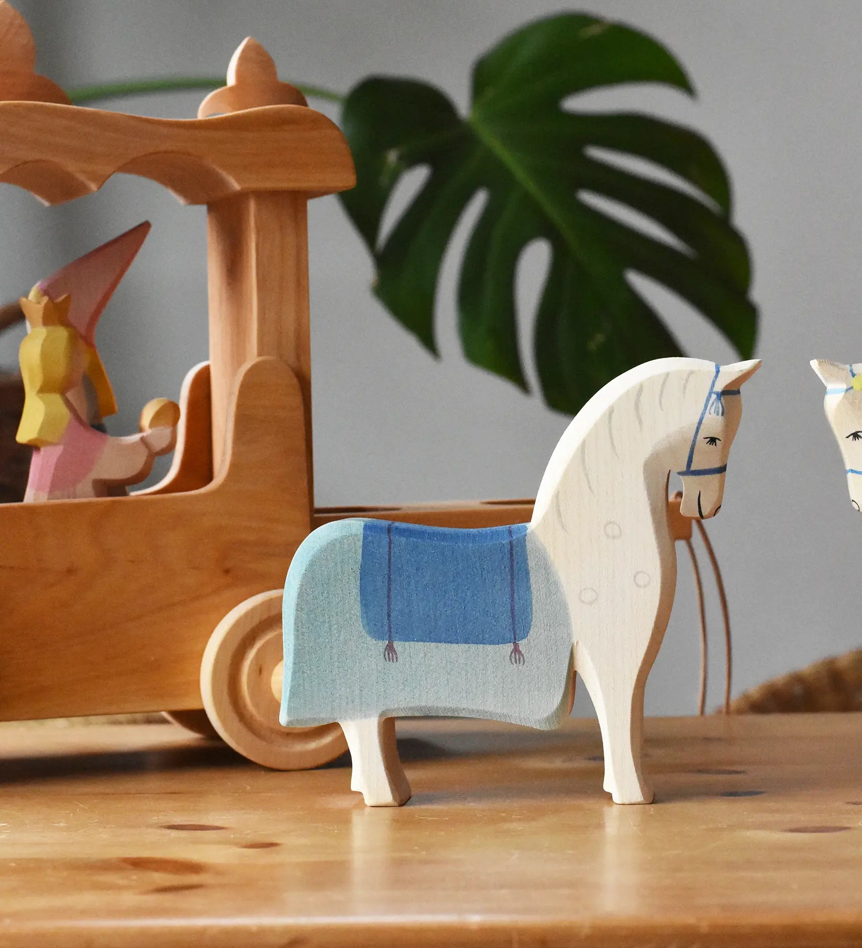 Ostheimer wooden white horse with saddle placed in front of the stage coach.