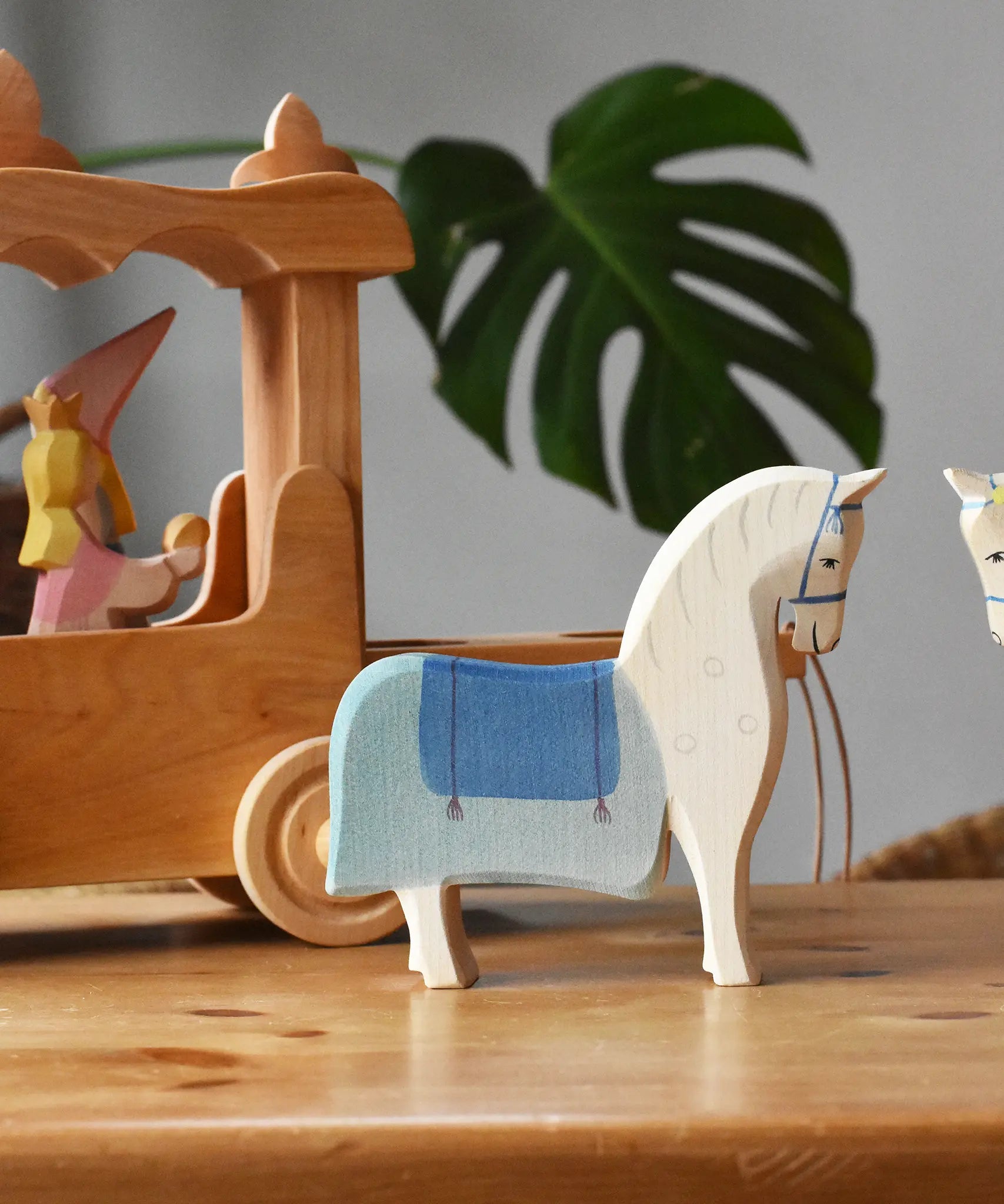 Ostheimer wooden white horse with saddle placed in front of the stage coach.