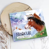Ostheimer Hrokur and the Skyriders children's book lying flat on a tree trunk