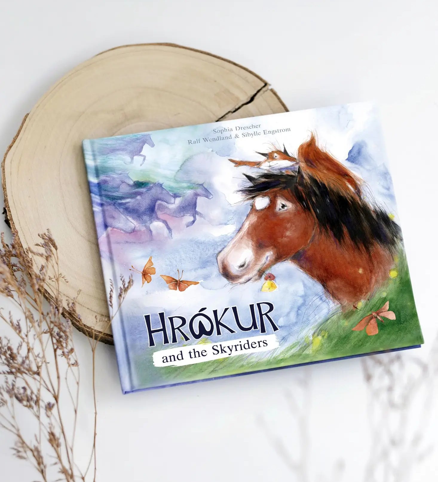 Ostheimer Hrokur and the Skyriders children's book lying flat on a tree trunk