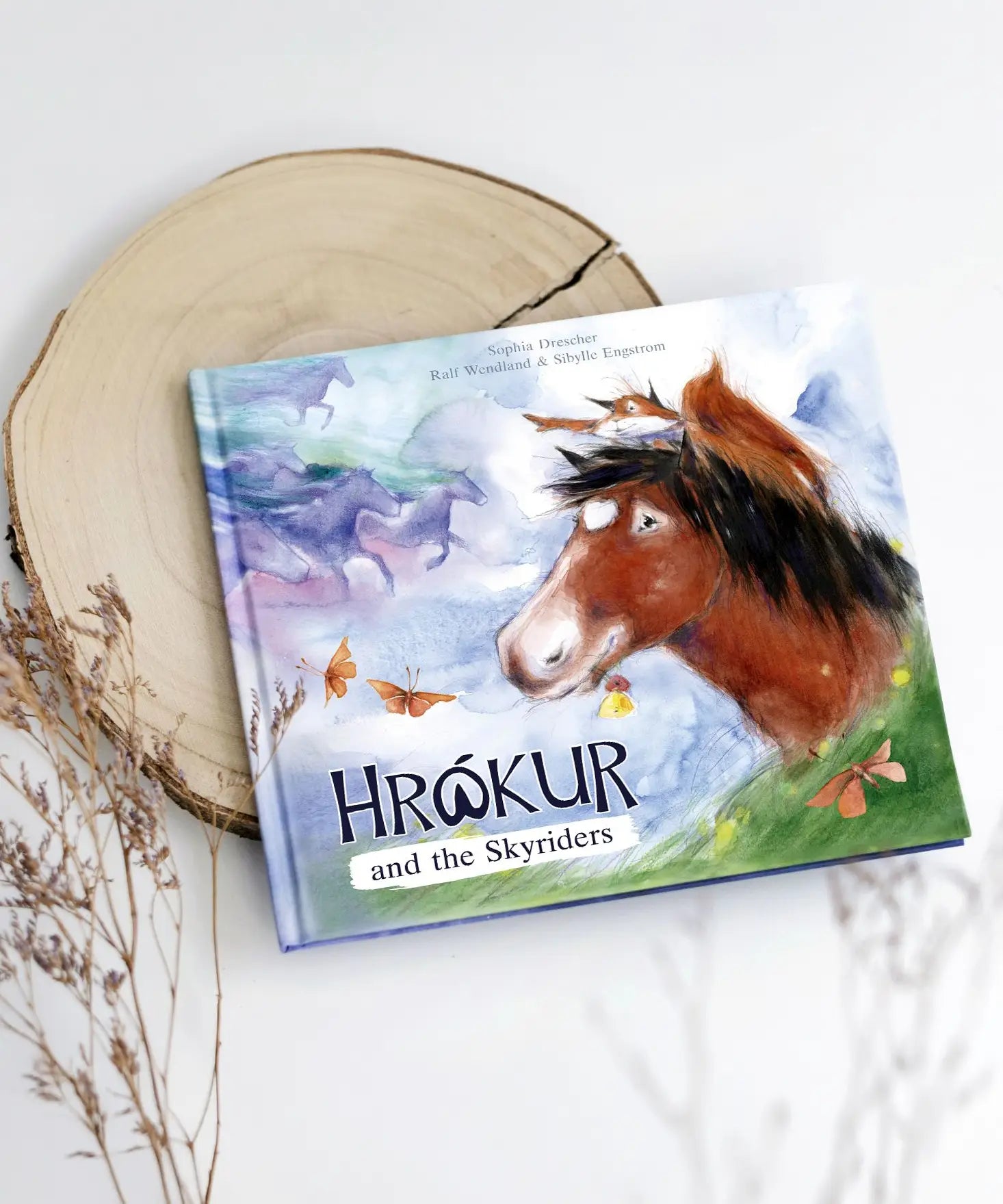 Ostheimer Hrokur and the Skyriders children's book lying flat on a tree trunk