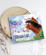 Ostheimer Hrokur and the Skyriders children's book lying flat on a tree trunk