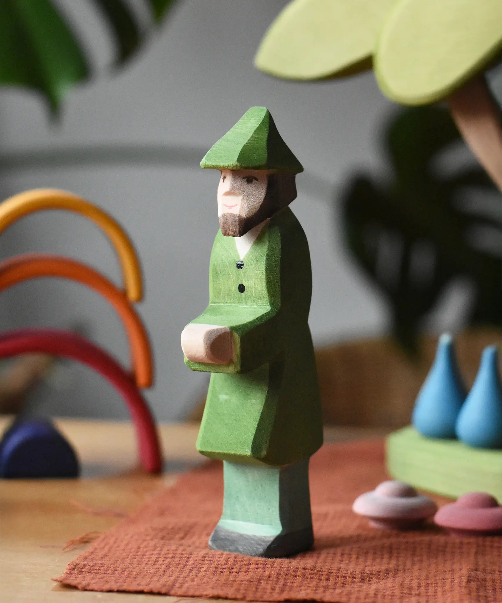 Ostheimer hunter wooden toy person figure placed in a small world play set up. 