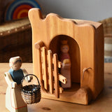 Ostheimer jailhouse wooden toy in a small world play scene with a princess figure placed inside and a female farmer placed outside with a Kraul basket filled with Billes sparkly marbles. 
