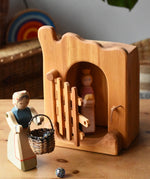 Ostheimer jailhouse wooden toy in a small world play scene with a princess figure placed inside and a female farmer placed outside with a Kraul basket filled with Billes sparkly marbles. 