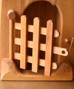 Close up of the trellised gate on the front of the Ostheimer jailhouse wooden toy.