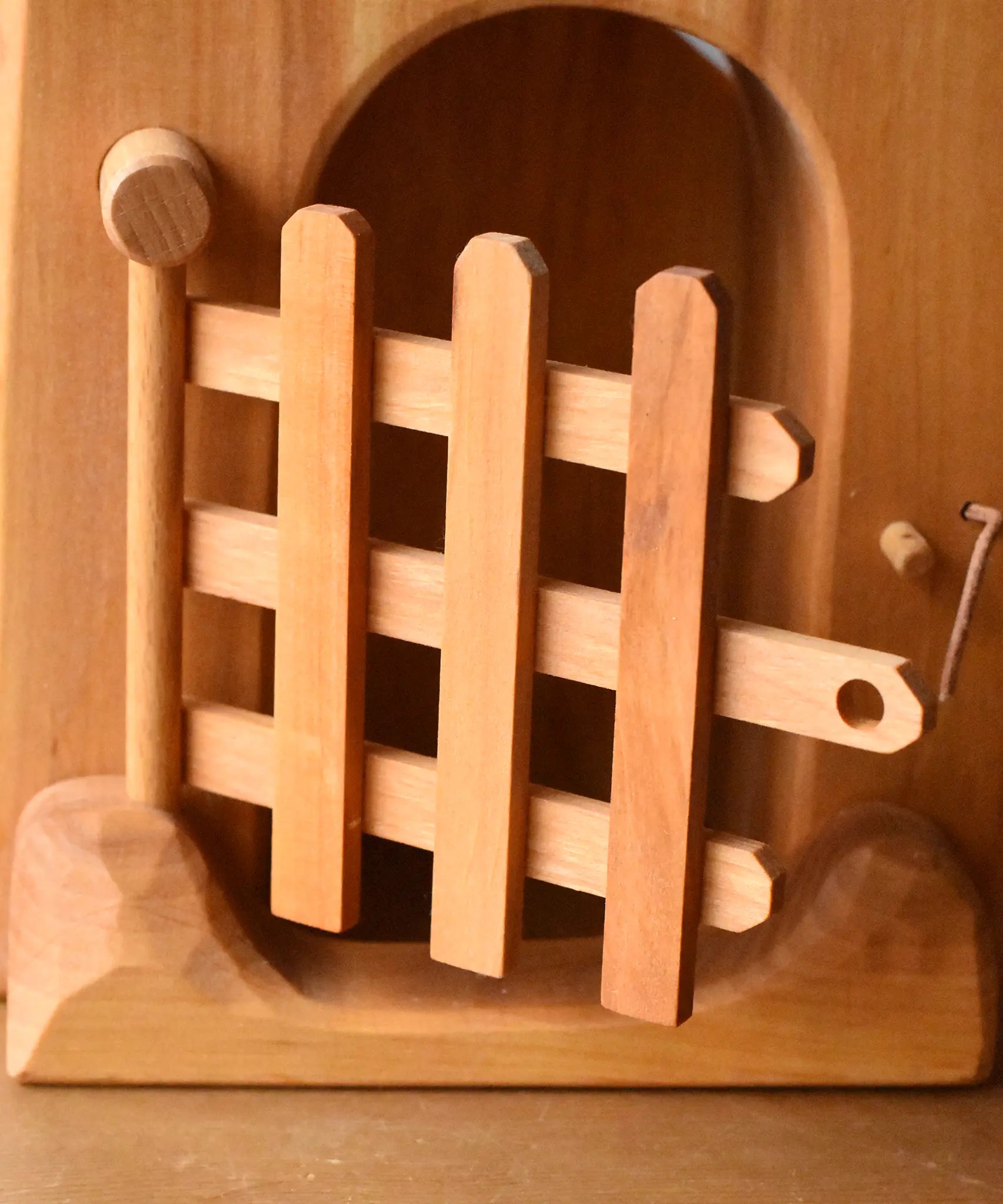 Close up of the trellised gate on the front of the Ostheimer jailhouse wooden toy.