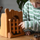 Ostheimer jailhouse wooden toy played with by a child opening the gate.
