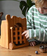 Ostheimer jailhouse wooden toy played with by a child opening the gate.