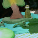 Ostheimer jumping frog handmade wooden toy figure placed in a small world play scene with other wooden toys from Ostheimer and Grapat.