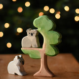 An Ostheimer sitting koala and koala wooden toy figures placed on and under the Ostheimer eucalyptus tree. These wooden figures are part of a wide range of expertly hand crafted wooden toys here at Babipur. 