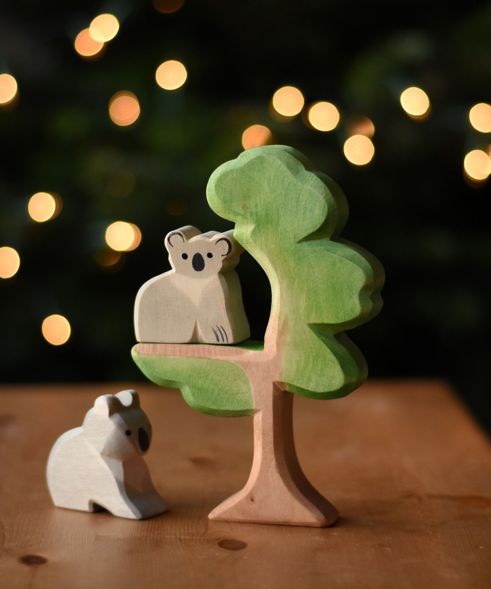An Ostheimer sitting koala and koala wooden toy figures placed on and under the Ostheimer eucalyptus tree. These wooden figures are part of a wide range of expertly hand crafted wooden toys here at Babipur. 