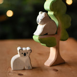 An Ostheimer sitting koala and koala wooden toy figures placed on and under the Ostheimer eucalyptus tree. These wooden figures are part of a wide range of expertly hand crafted wooden toys here at Babipur. 