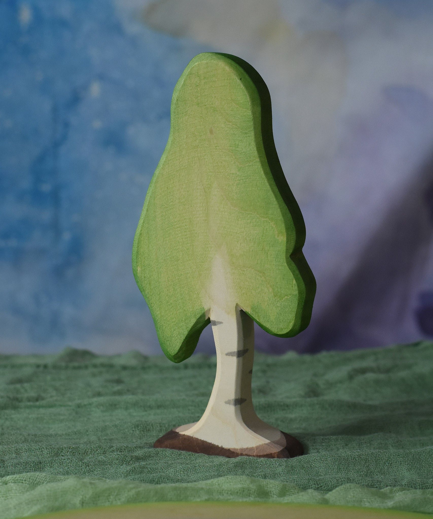 A large Ostheimer birch tree placed on a green coloured Ostheimer decoration scarf. This wooden figure is part of a large range of expertly hand crafted, Waldorf inspired, wooden toys here at Babipur. 