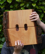Ostheimer large wooden castle walls in a child's hands peering through.