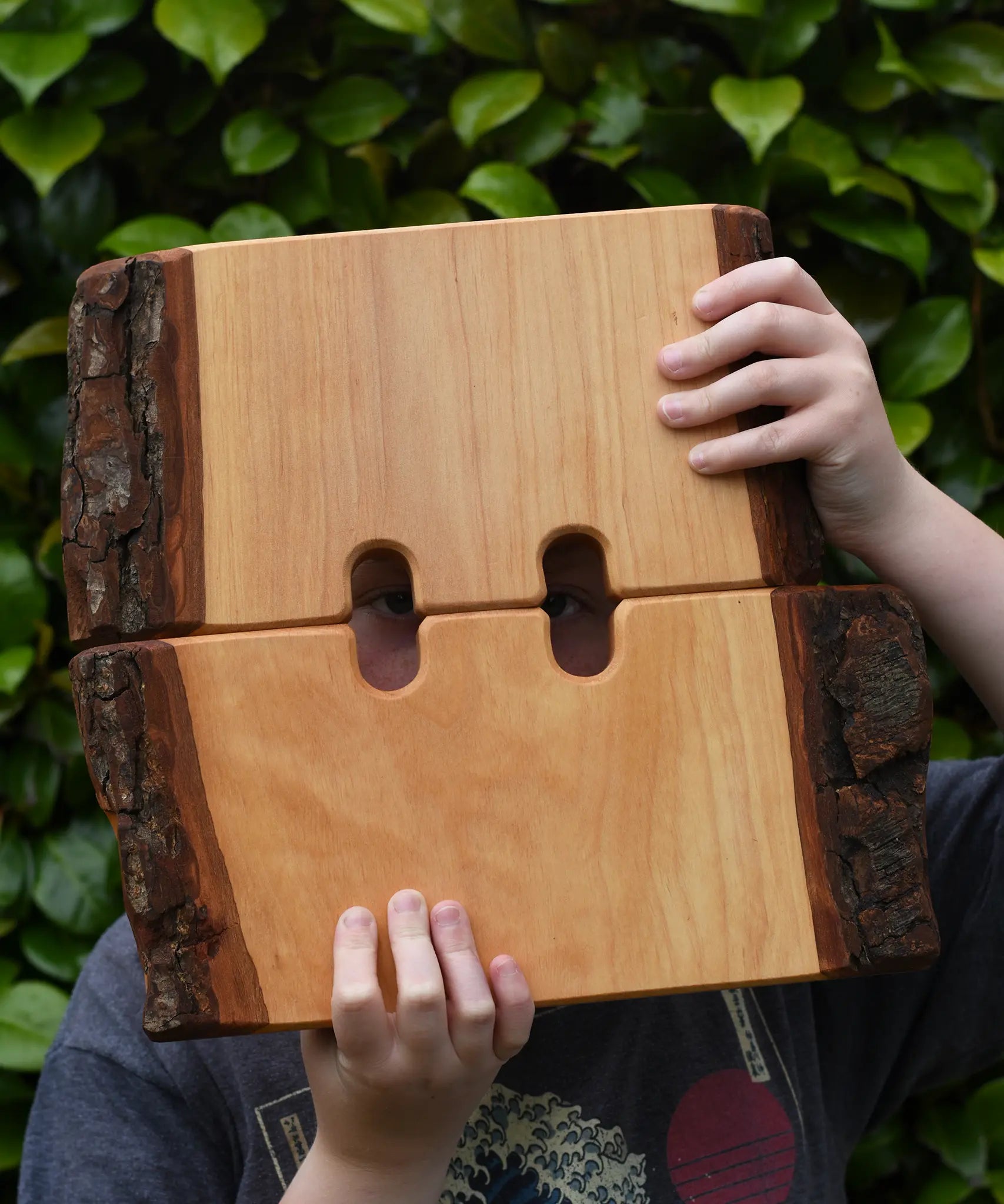 Ostheimer large wooden castle walls in a child's hands peering through.