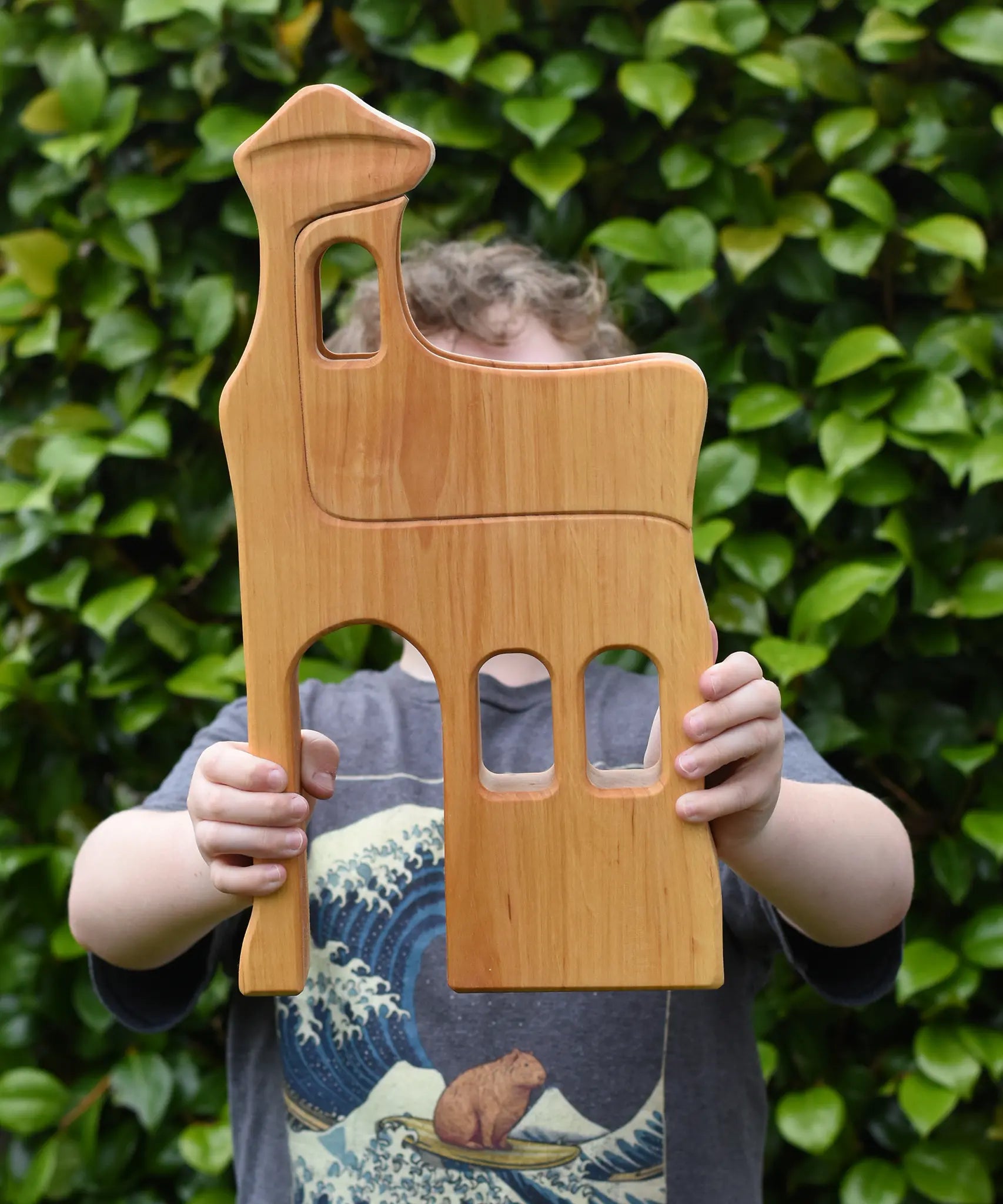 Ostheimer large wooden lookout tower wooden toy in a child's hands.