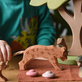 Ostheimer leopard placed in a small world play scene with a child holding it's rope tail.