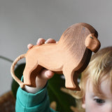 Ostheimer wooden toy lion figure in a child's hand. 