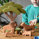 Ostheimer lion, lioness and cubs wooden toy figures placed in a small world play scene with the African tree and Grapat mandala pieces. 