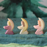 Three little Ostheimer angels lined up and placed on green coloured decorative Ostheimer scarfs. These wooden figures are part of a wide range of expertly hand crafted wooden toys here at Babipur. 
