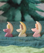Three little Ostheimer angels lined up and placed on green coloured decorative Ostheimer scarfs. These wooden figures are part of a wide range of expertly hand crafted wooden toys here at Babipur. 
