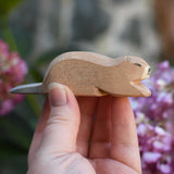 An Ostheimer beaver wooden toy figure, the beaver is in a laying down position. Check out our full range of expertly crafted wooden toy figures and scenery here at Babipur.
