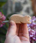 An Ostheimer beaver wooden toy figure, the beaver is in a laying down position. Check out our full range of expertly crafted wooden toy figures and scenery here at Babipur.