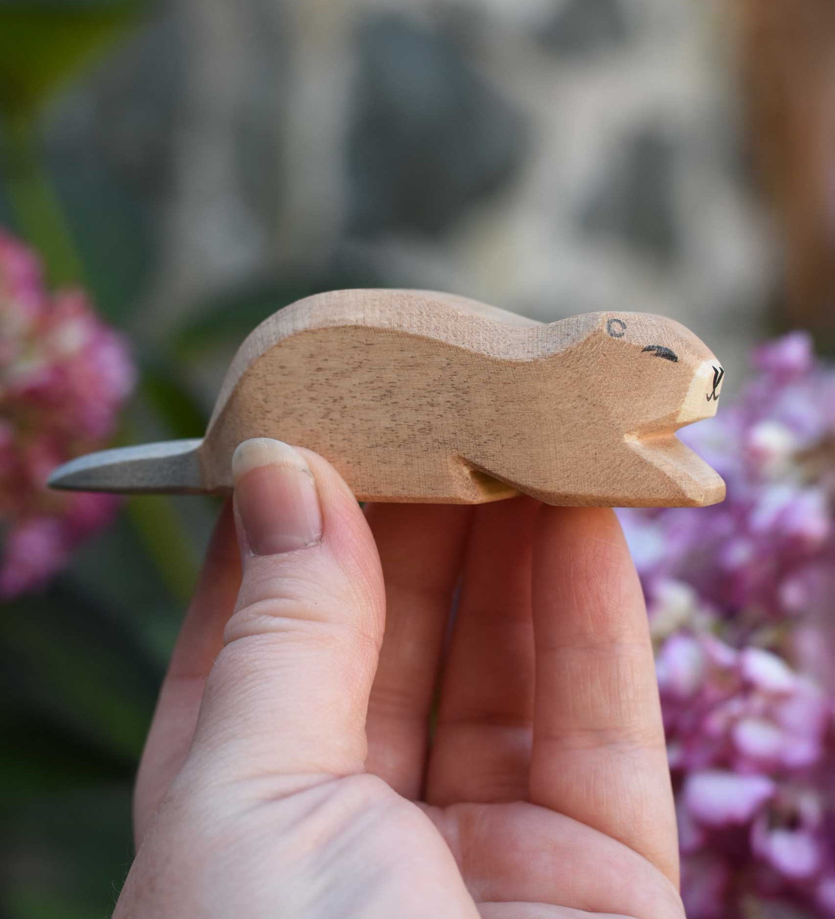 An Ostheimer beaver wooden toy figure, the beaver is in a laying down position. Check out our full range of expertly crafted wooden toy figures and scenery here at Babipur.