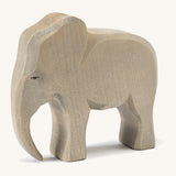 A wooden male Ostheimer elephant figure on a cream background.