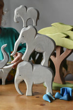 Ostheimer male, female and small eating wooden toy figures stacked on top of each other.