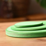 Side profile view of the Ostheimer 3 piece meadow green base play bases.