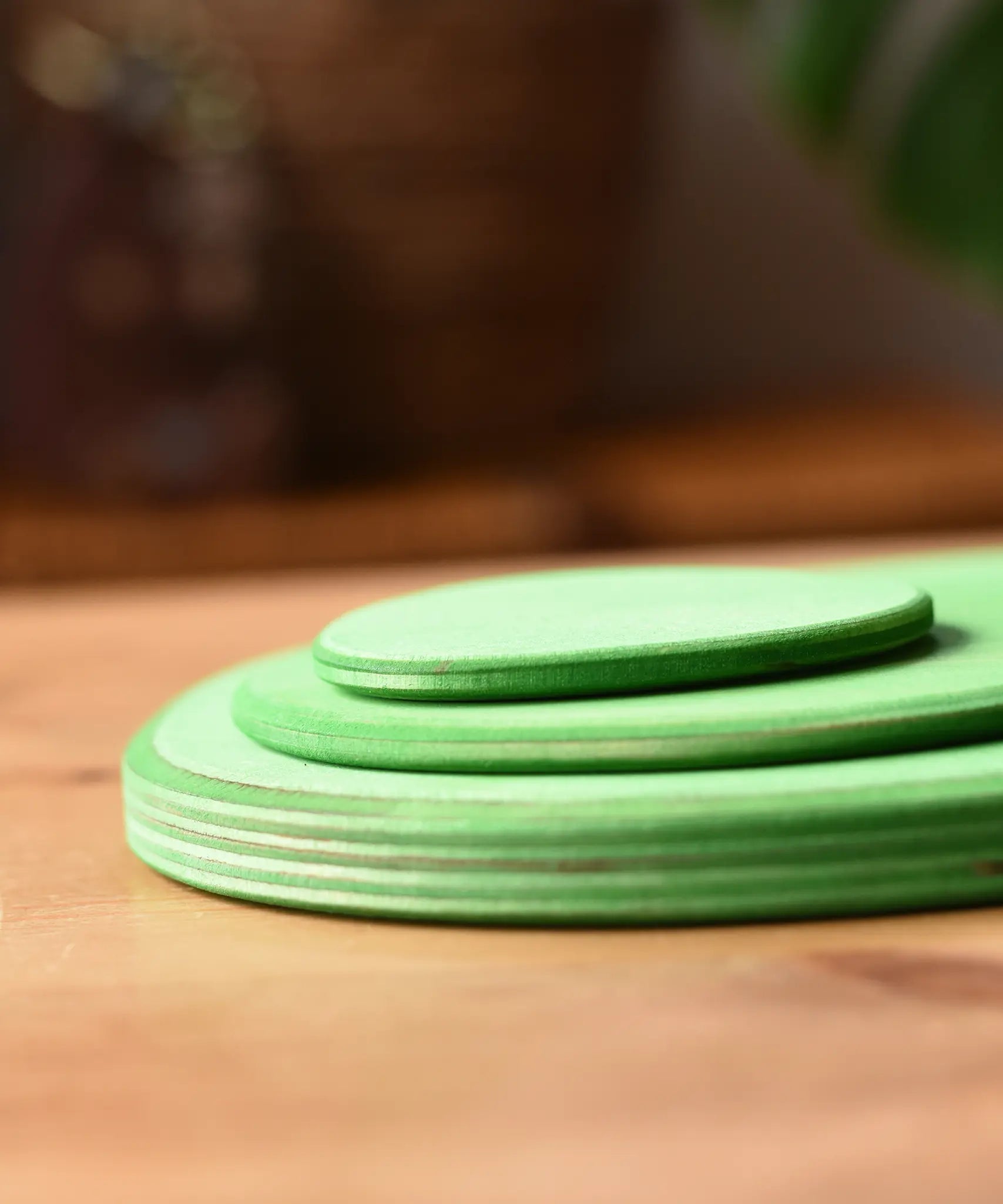 Side profile view of the Ostheimer 3 piece meadow green base play bases.