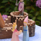 Two Ostheimer wooden princess figures placed in front of the Magic Wood castle. These wooden figures are part of a large range of expertly and crafted, Waldorf inspired, wooden toys here at Babipur. 