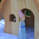 An Ostheimer Medieval Princess wooden toy figure placed in front of a Ostheimer fairy tale dolls house. This wooden figure is part of a large range of expertly hand crafted, Waldorf inspired, wooden toys here at Babipur. 