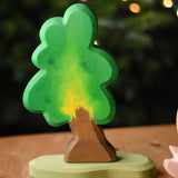 A medium Ostheimer oak tree with support placed on a wooden surface. These wooden figures are part of a wide range of expertly hand crafted wooden toys here at Babipur.