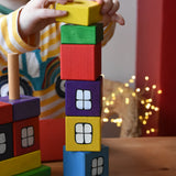 Child stacking the blocks from the Ostheimer multi coloured block house on top of each other.
