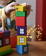 Child stacking the blocks from the Ostheimer multi coloured block house on top of each other.