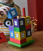 Child playing with the Ostheimer multi coloured block house.