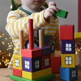 Child playing with the Ostheimer multi coloured block house.