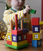 Child playing with the Ostheimer multi coloured block house.