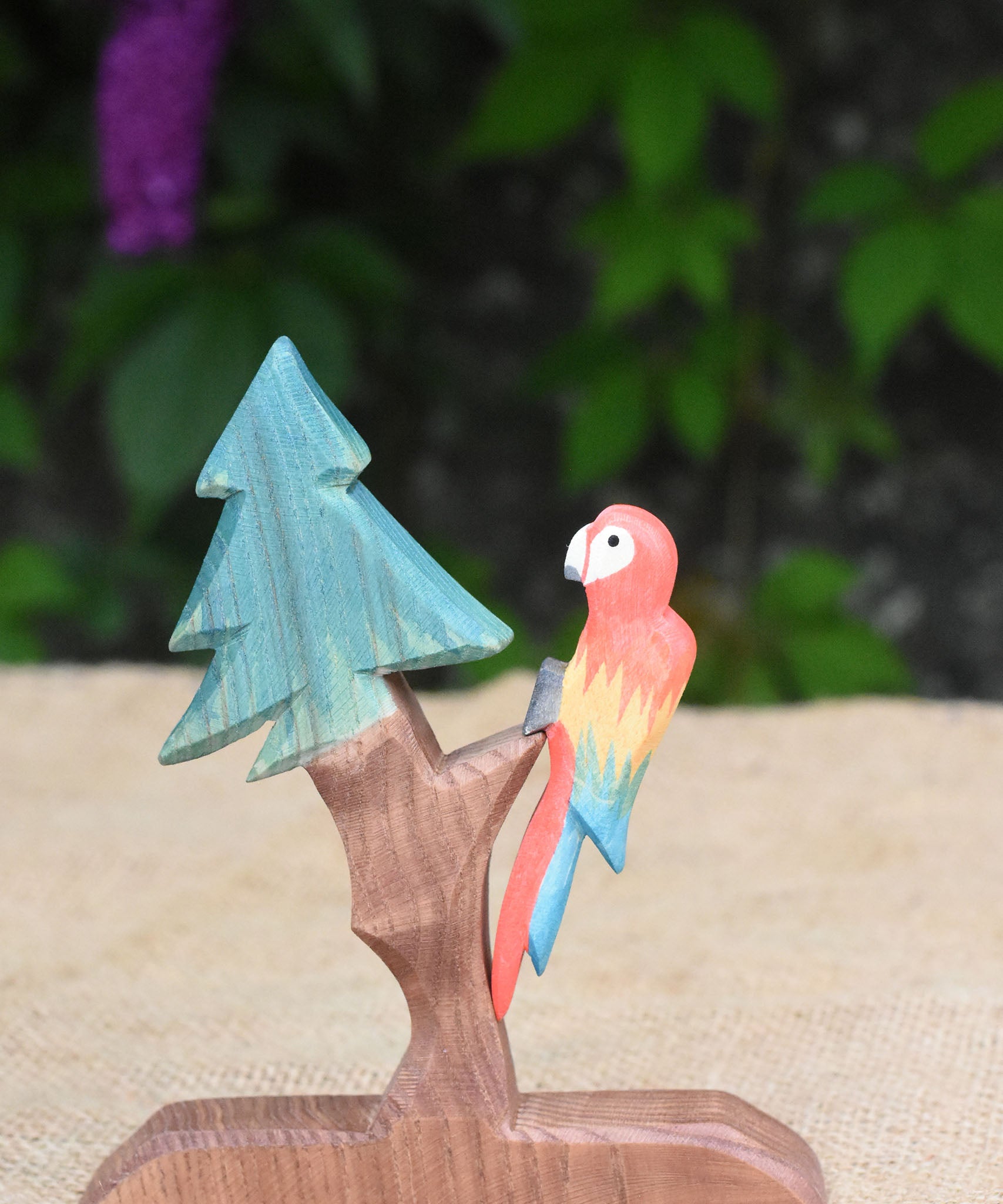 An Ostheimer multi-colour parrot placed on a fir tree for dwarves.