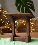 Ostheimer wooden nativity manger with roof placed on a green cotton play cloth.