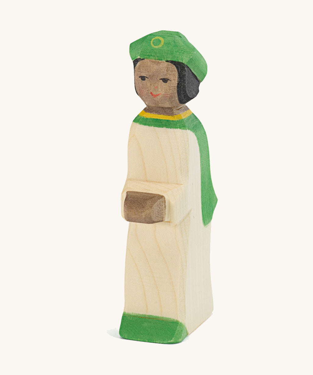Ostheimer Green King’s Page wooden nativity figure, a Waldorf inspired Star Singer with black skin and black hair, wearing a white robe with a green cloak and green hat, hand painted 