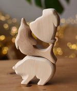 Three Ostheimer natural  wooden rabbit wooden toy figures stack on top of each other, bear, dolphin and rabbit..