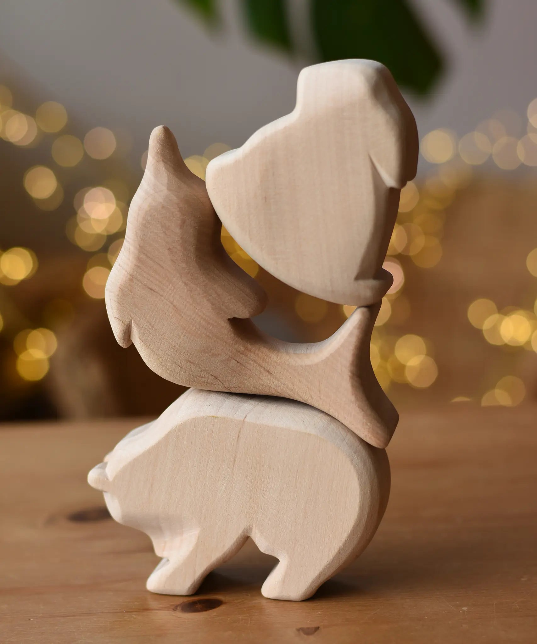 Three Ostheimer natural  wooden rabbit wooden toy figures stack on top of each other, bear, dolphin and rabbit..