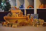 The Ostheimer ark set up with the ship's cabin and lots of wooden animal figures on and around the ark. 